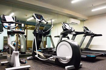 Fitness center with cardio machines at Surrey Village in Surrey, BC